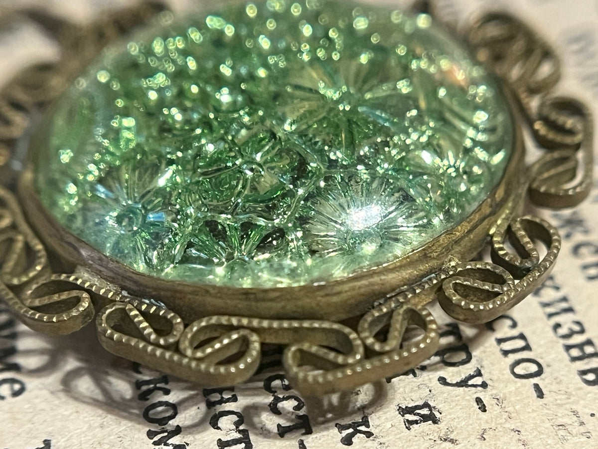Macro detail of molded floral pattern in iridescent vintage glass