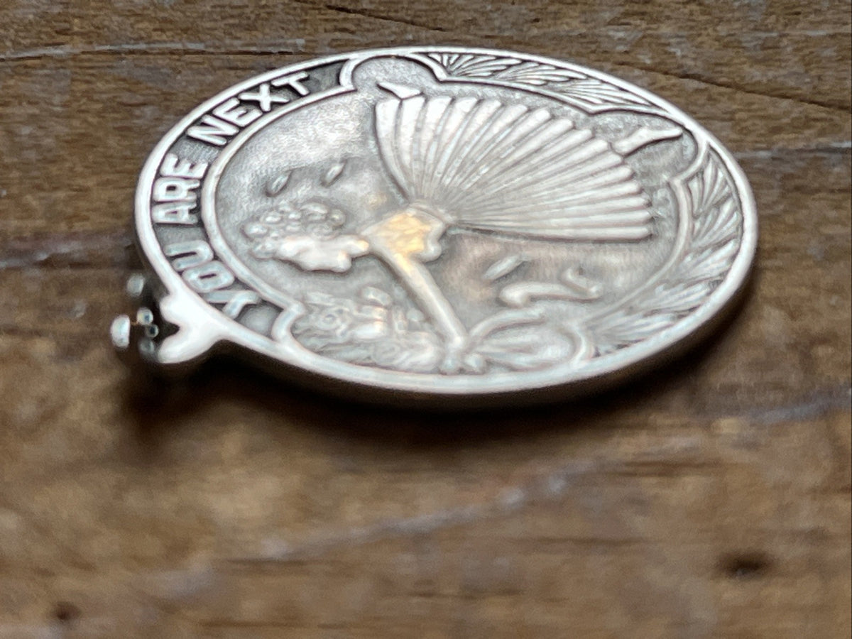 Angled close-up of the bridal charm's raised bouquet design
