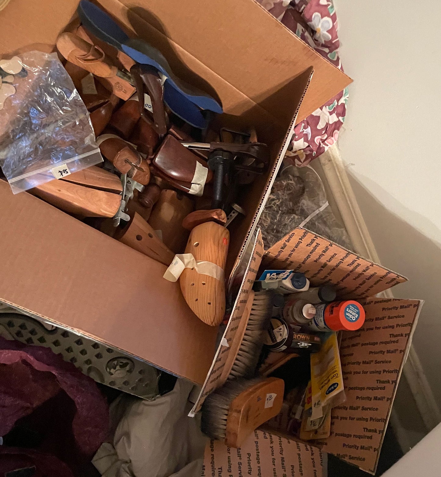 Box filled with various items including shoes and bottles on a surface.