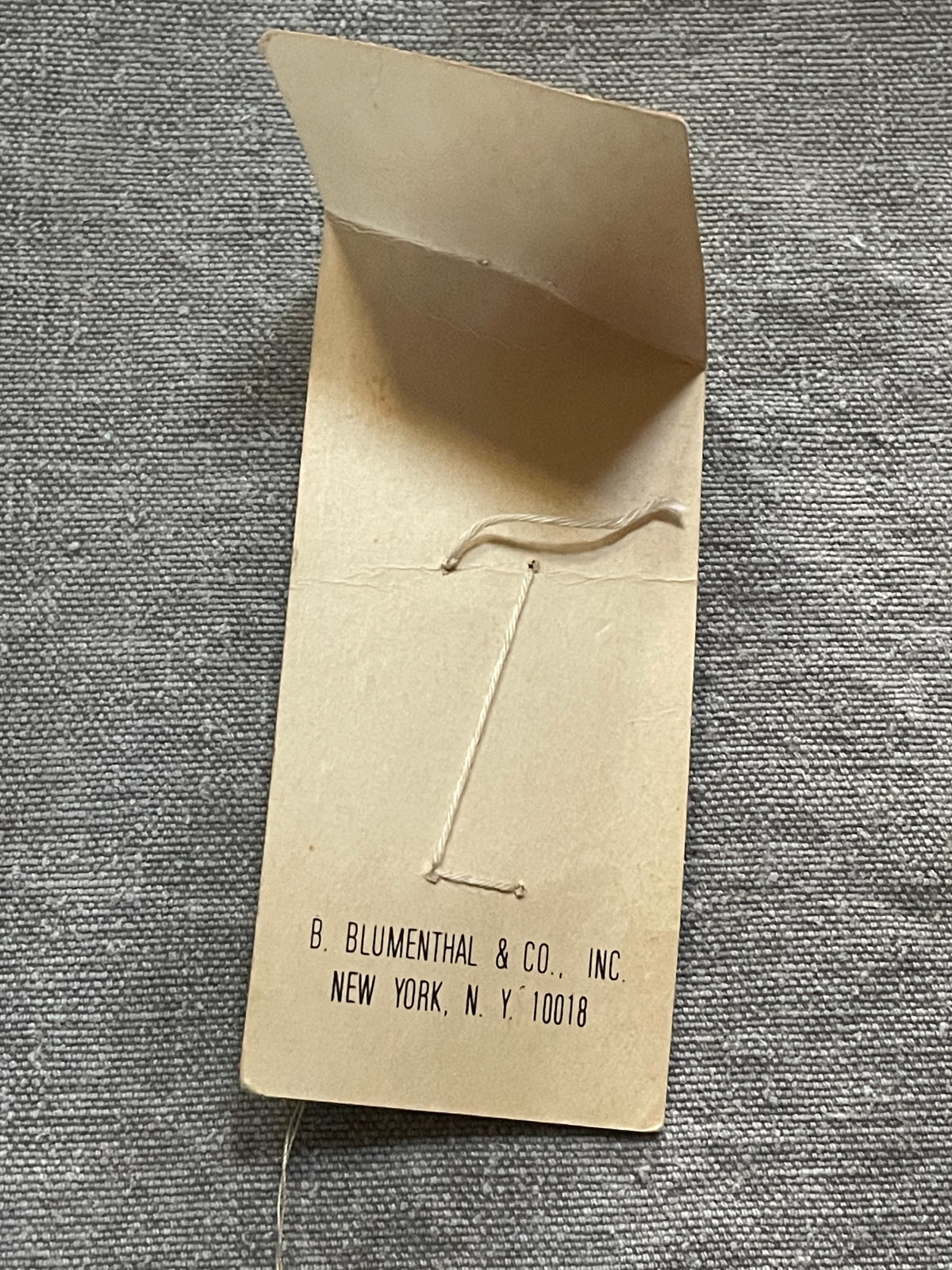 Back of original packaging card for 2 white le chic sewing buttons, 1 1/16 inch, original card
