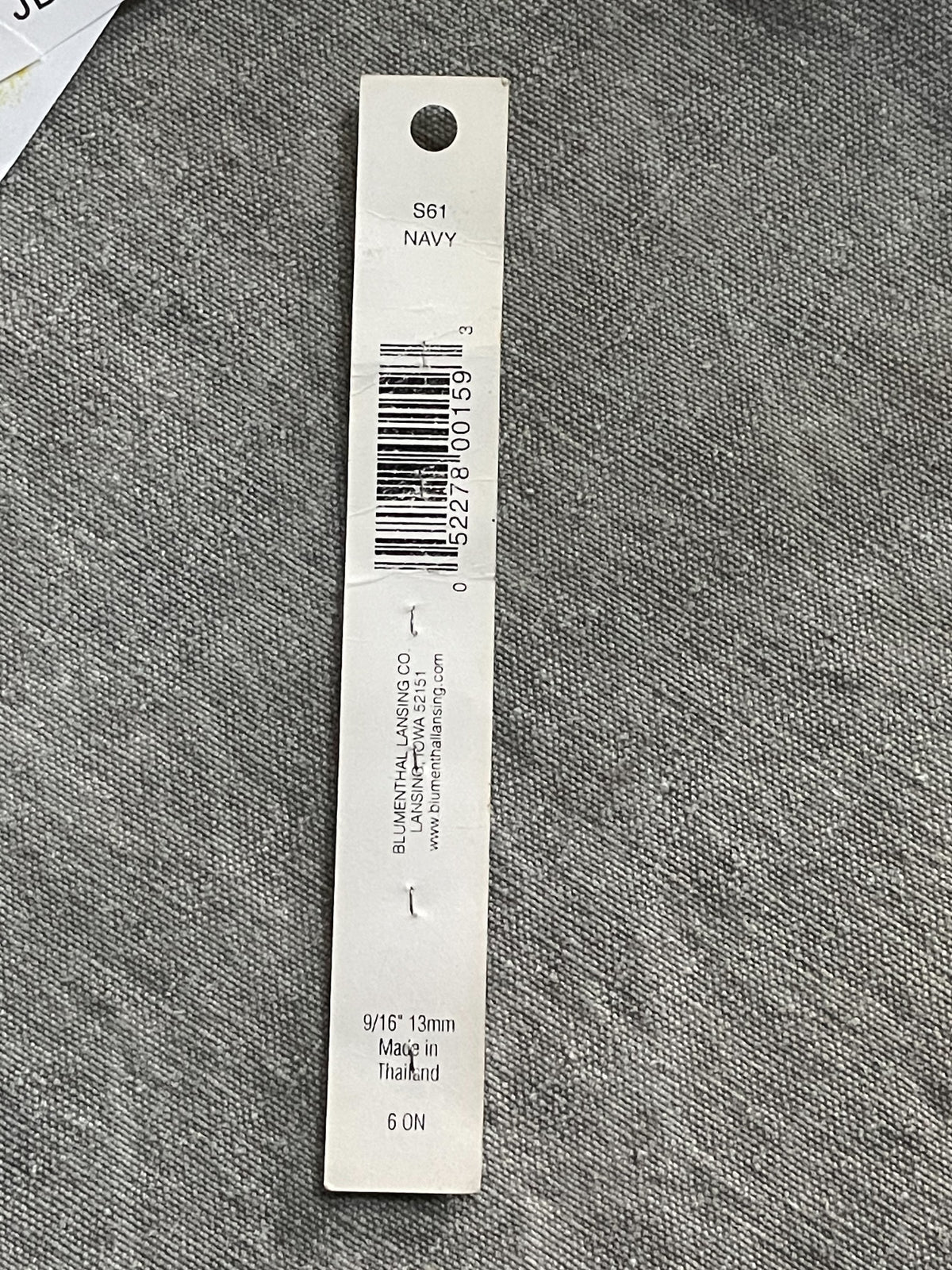 Back of original packaging card for 4 navy blue slimline two-hole sewing buttons, 13.91 mm, original card