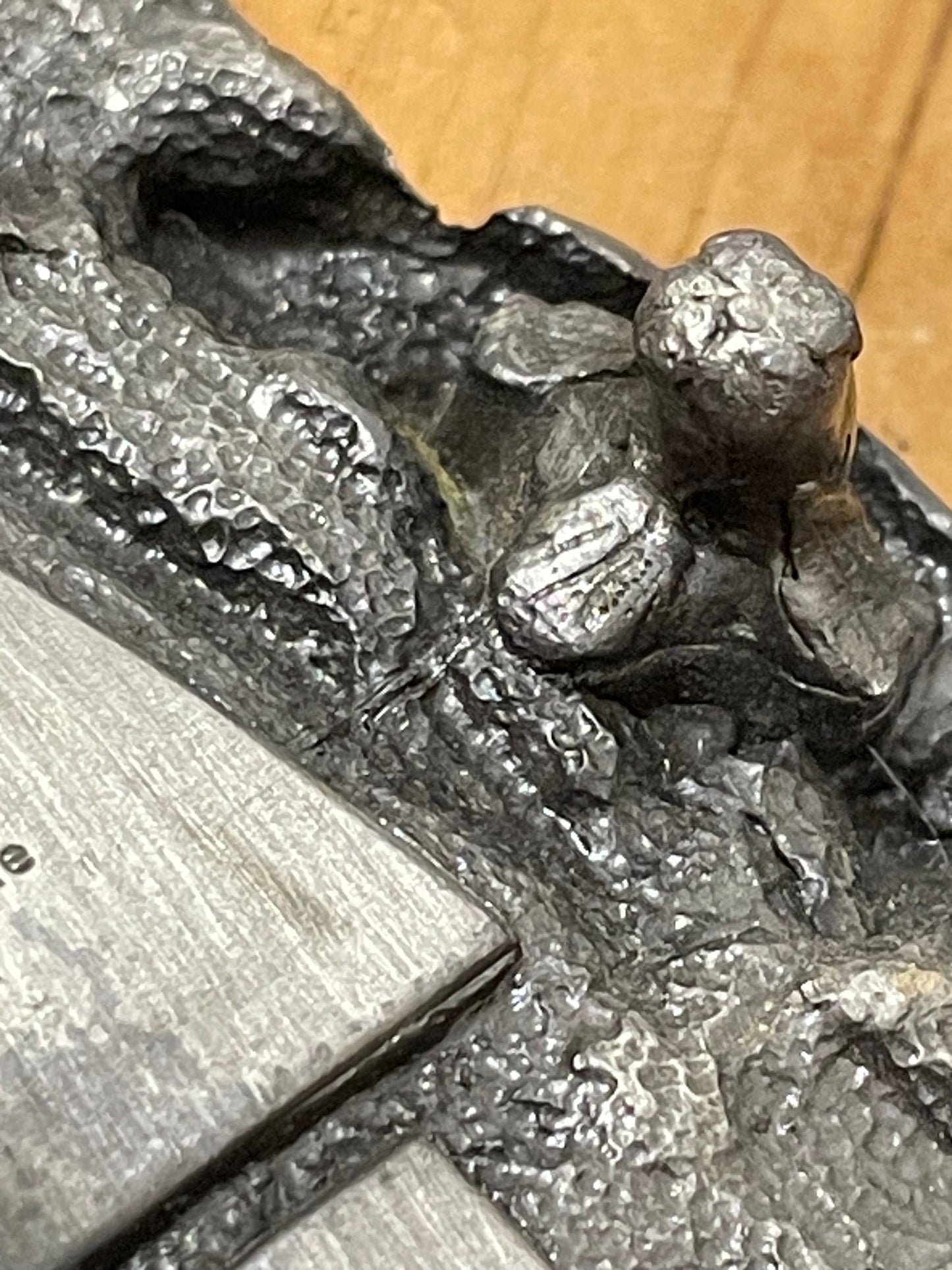 Extreme closeup of a metal belt buckle's fine details