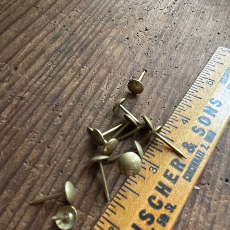 New old stock: one dozen decorative brass upholstery nails .3" head diameter / .67" length