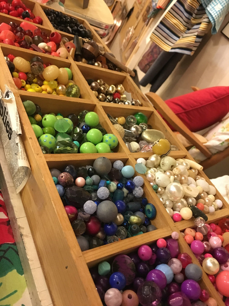 Colorful vintage beads arranged in a display bin inside the original Junket shop.