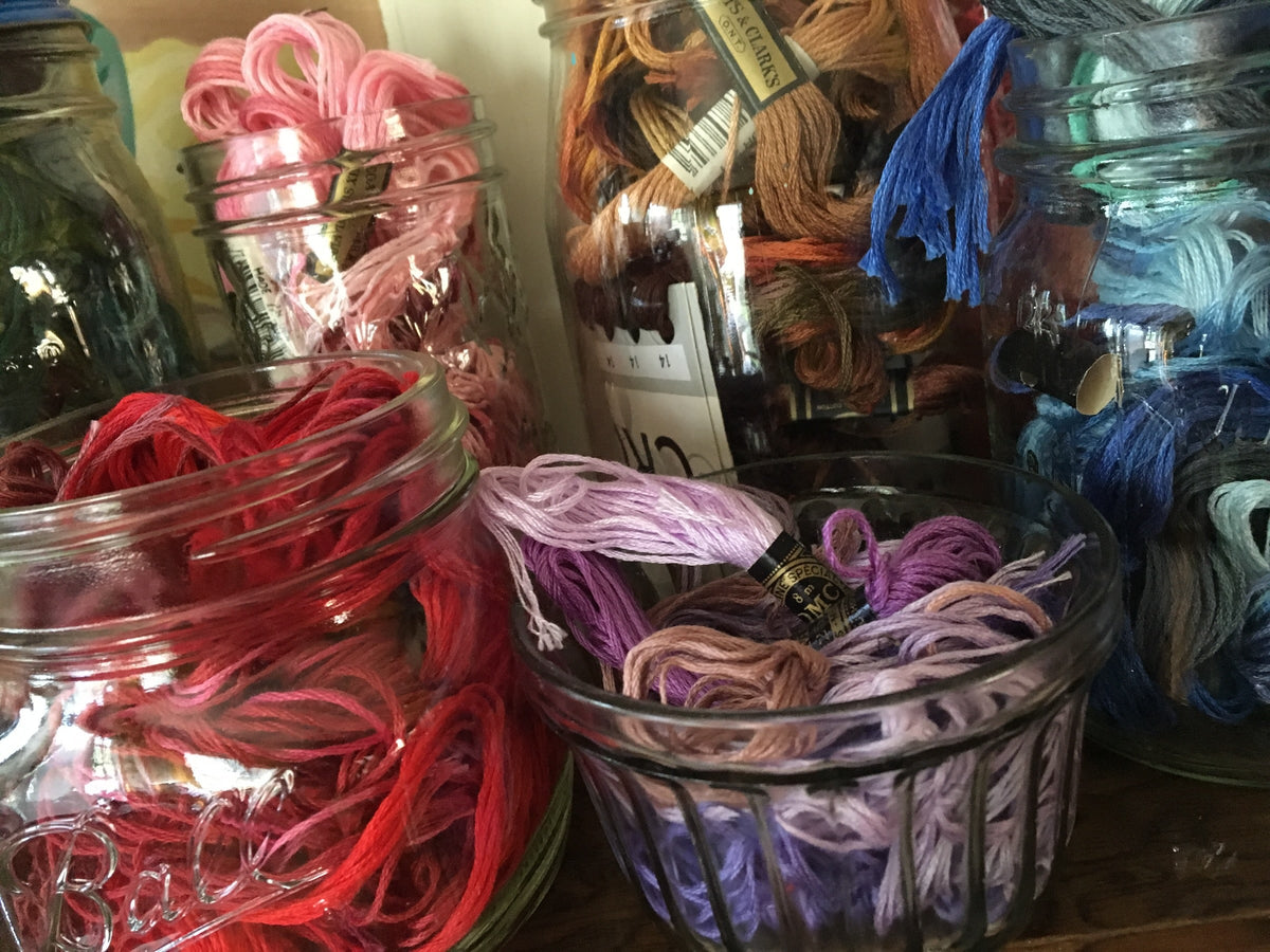 Embroidery Floss organized by color in vintage canning jars at the old shop.
