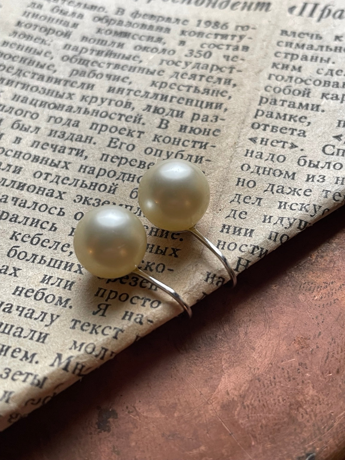 Pair of vintage Crown Trifari cream faux pearl clip-on earrings with silver-tone findings