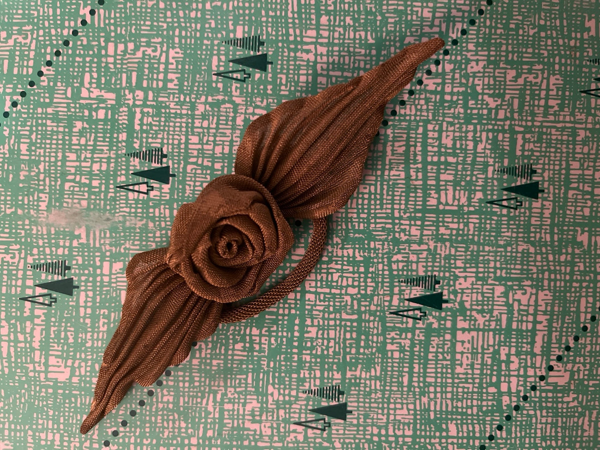 Full view of large vintage metal mesh rose brooch with flower, leaves and curved stem