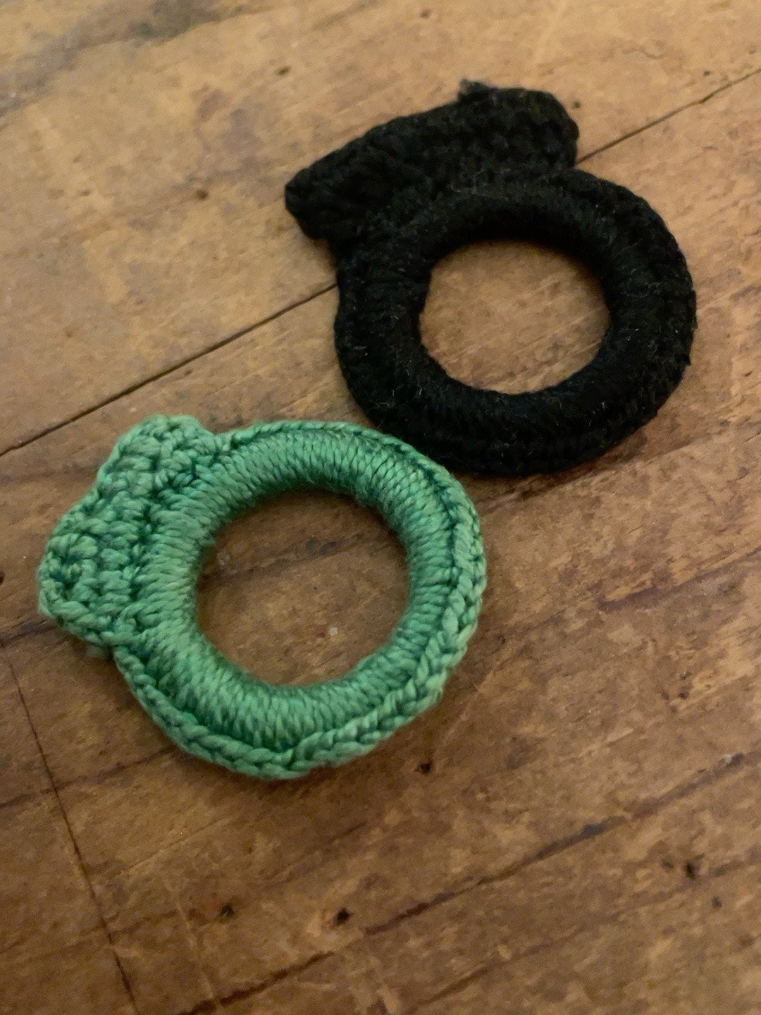 Black and mint-green vintage fiber ring pins shown from the front
