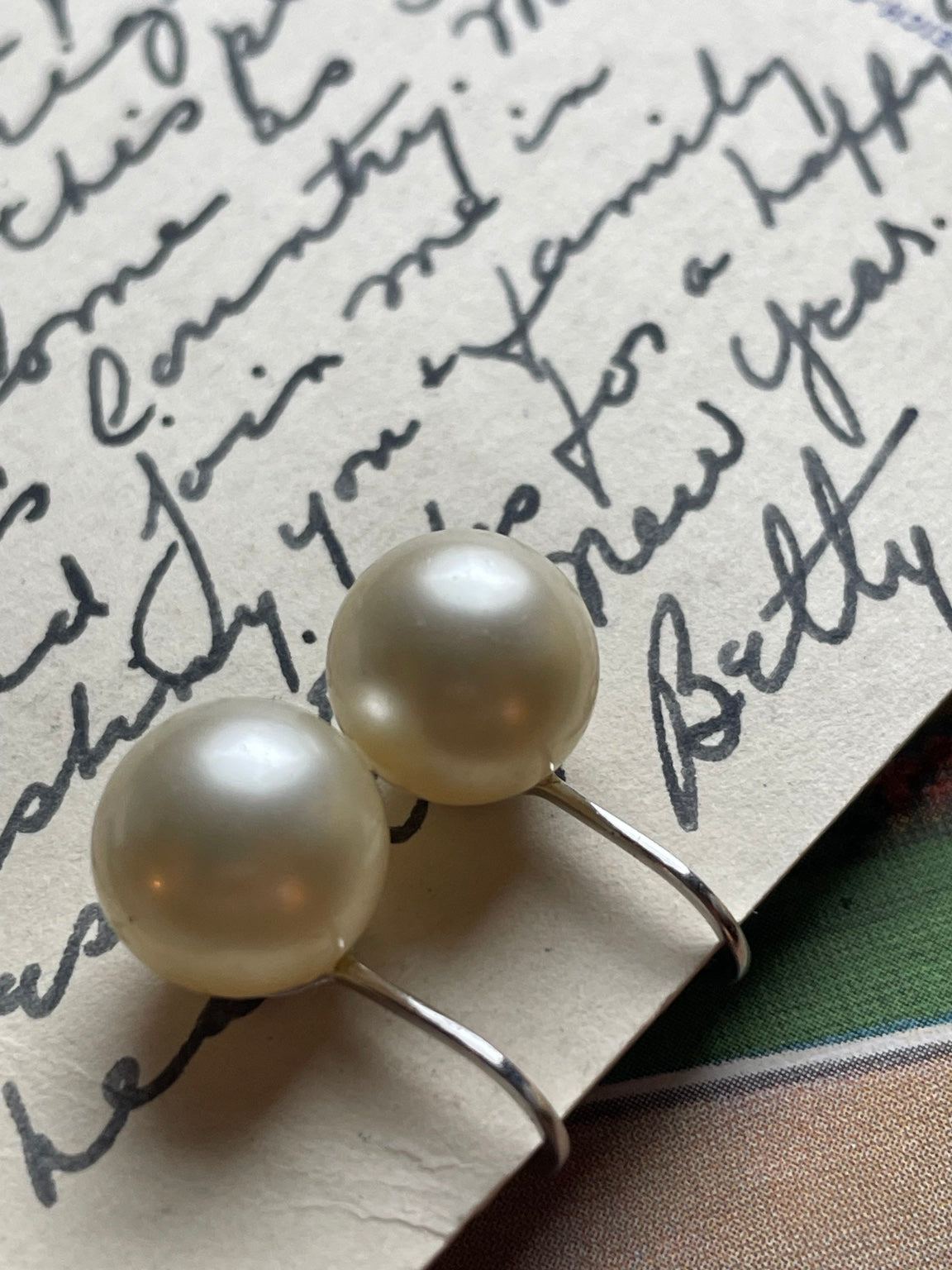 Vintage Crown Trifari faux pearl clip-on earrings in angled detail view