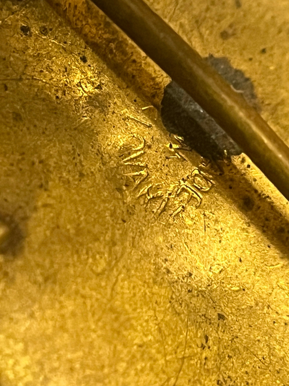 Close view of partial SLOVAKIA country mark on vintage filigree accessory
