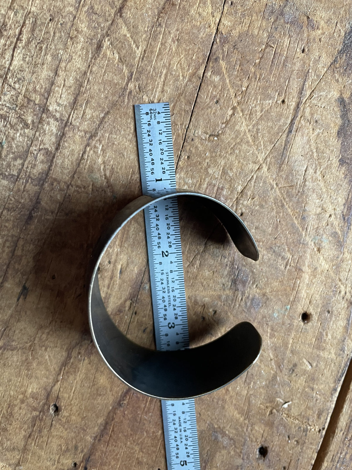 Vintage etched cuff bracelet shown with ruler for opening size