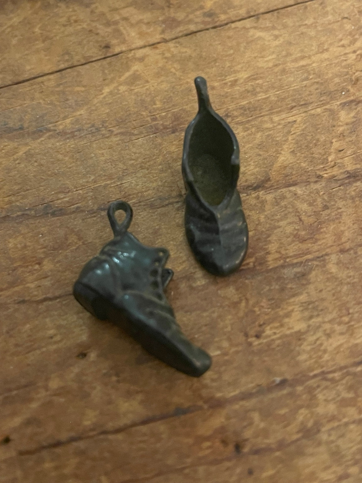 Pair of dimensional vintage miniature boot charms from an alternate angle