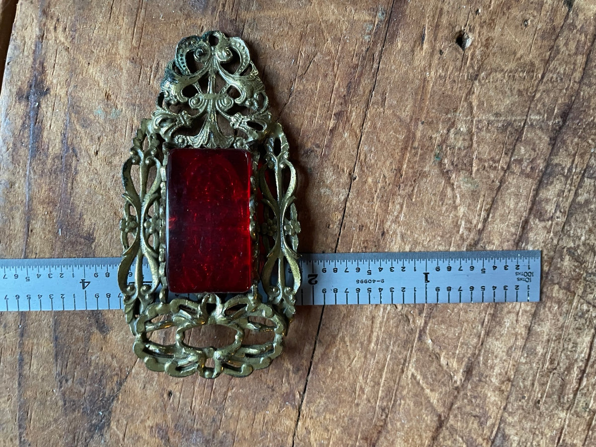 Vintage red glass brooch shown with ruler for width