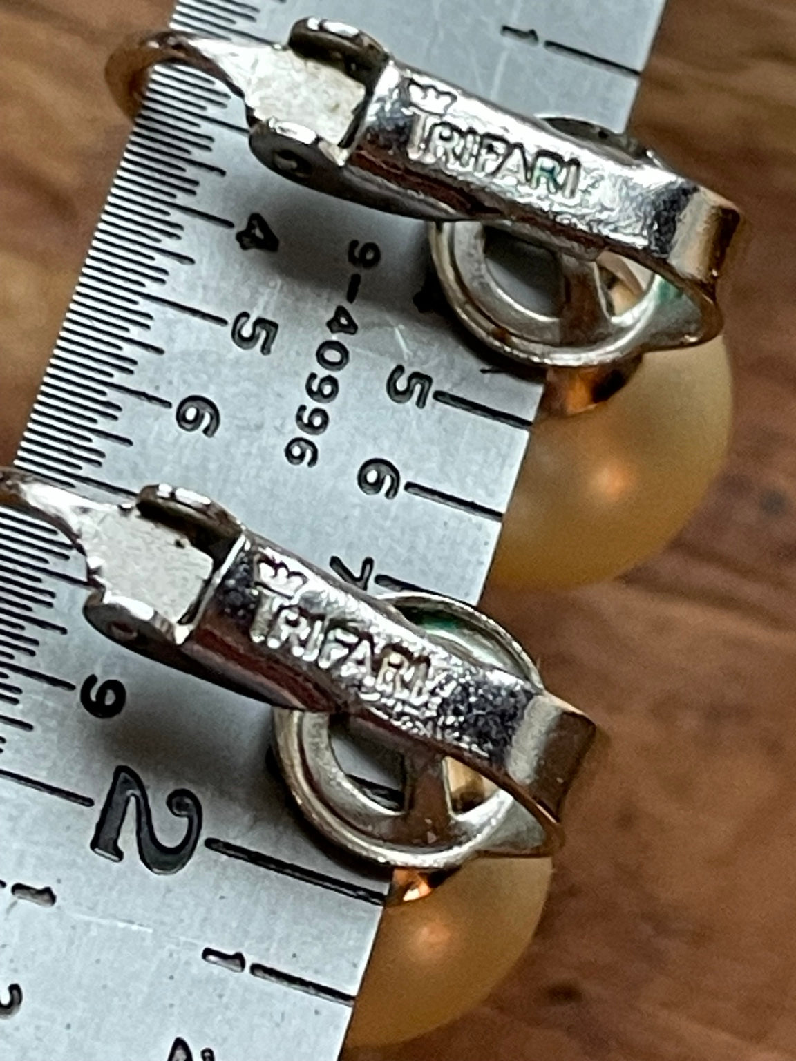 Close-up of CROWN TRIFARI maker mark on vintage clip-on earring