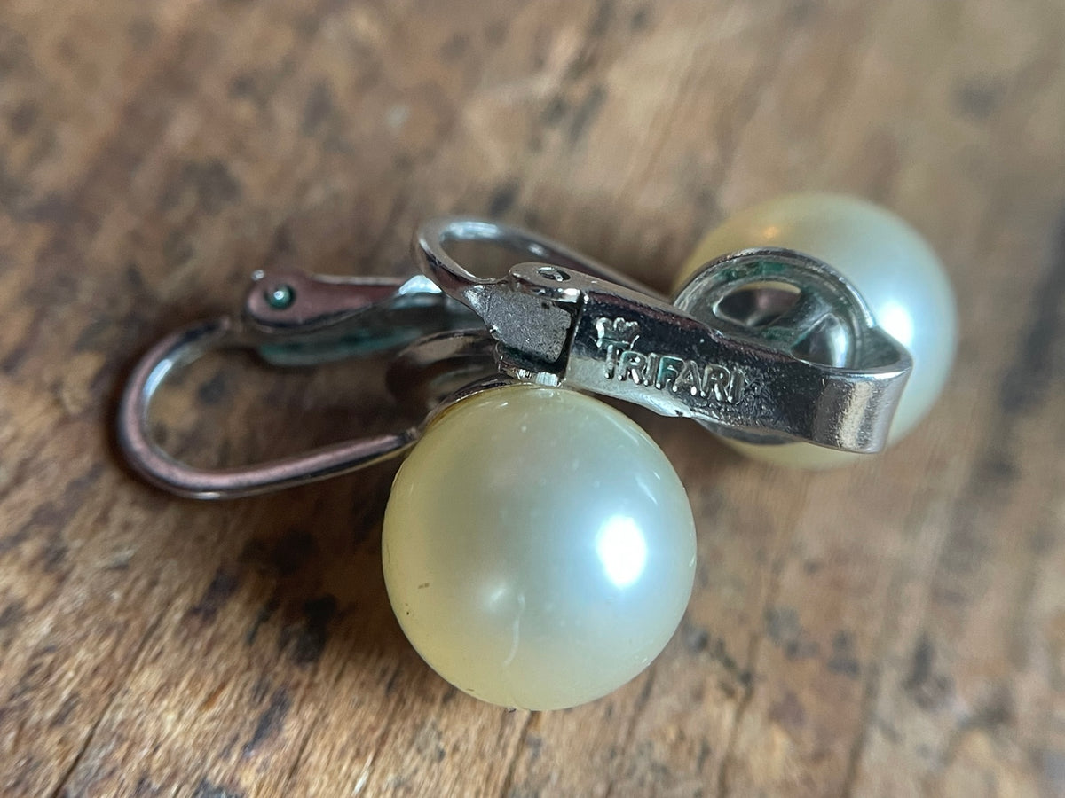 Close-up of vintage Trifari faux pearl earring clip construction and surface detail