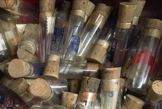 Ten antique glass watchmaker's vials