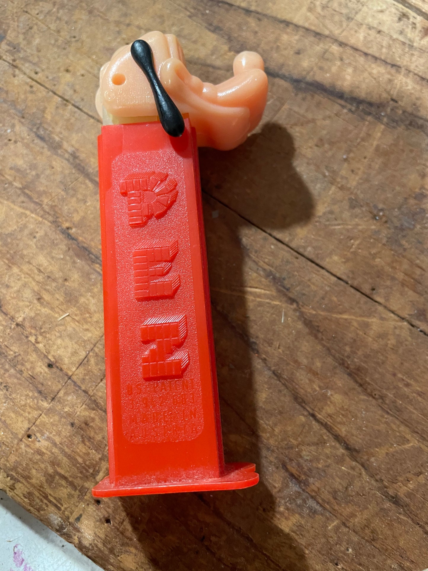 Detail of red Goofy PEZ stem showing U.S. Patent 3,942,683 and Made in Austria markings