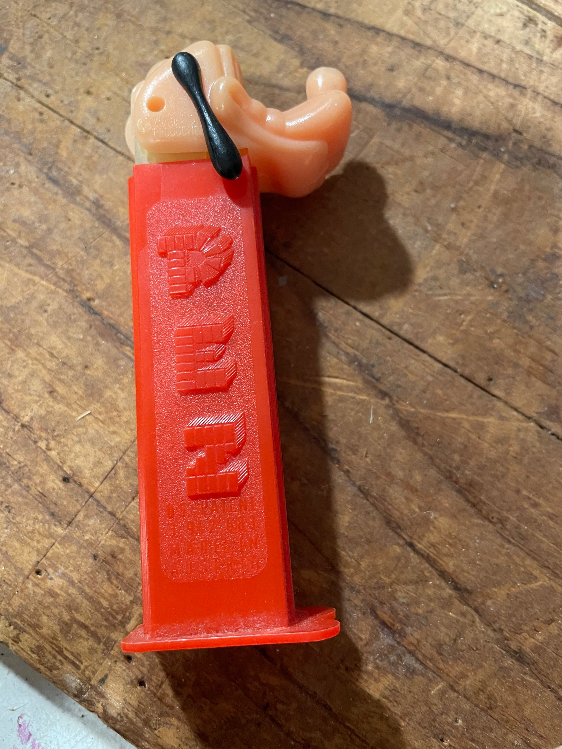 Detail of red Goofy PEZ stem showing U.S. Patent 3,942,683 and Made in Austria markings