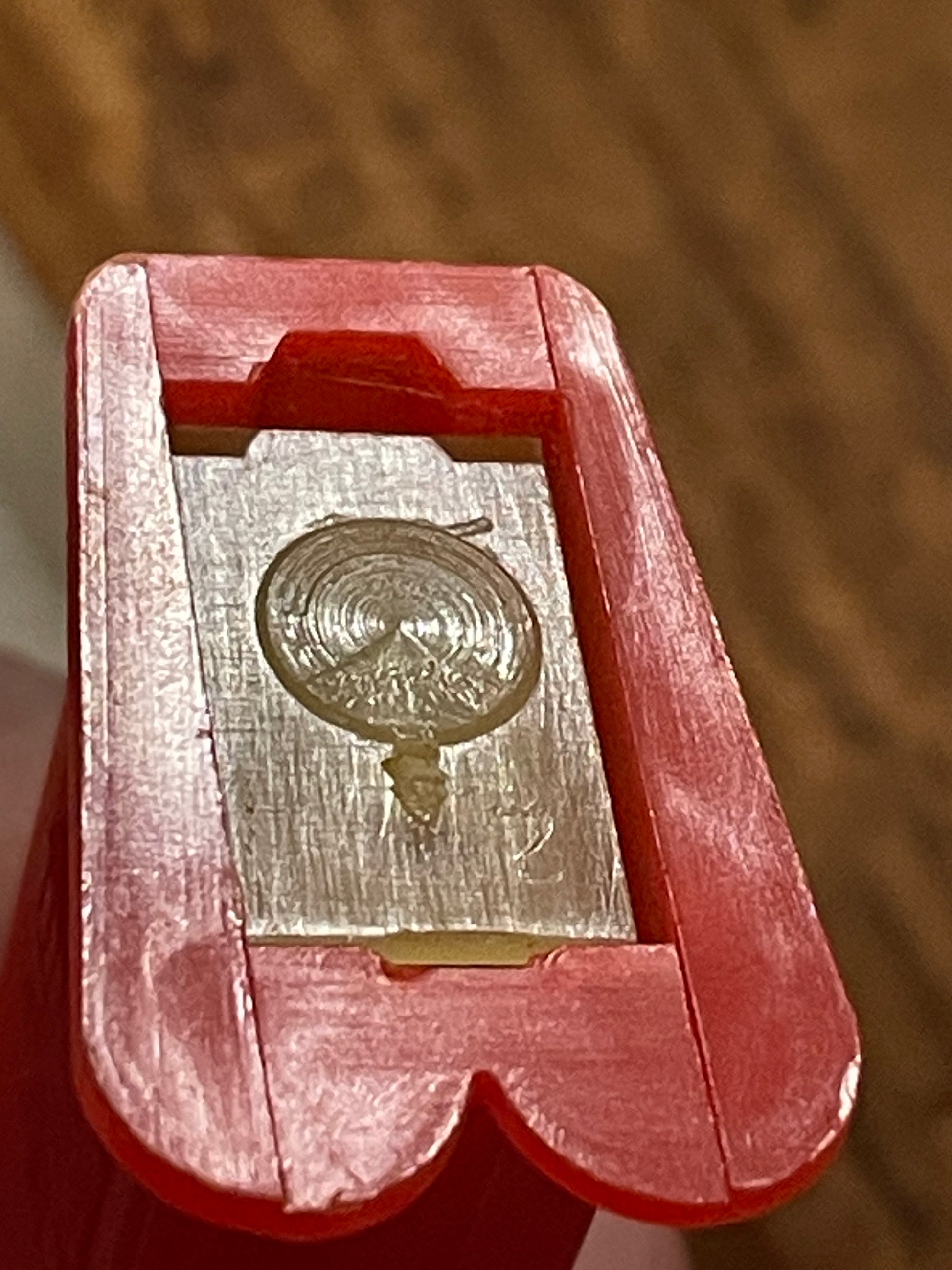 Underside and internal construction detail of vintage red-stem Goofy PEZ dispenser