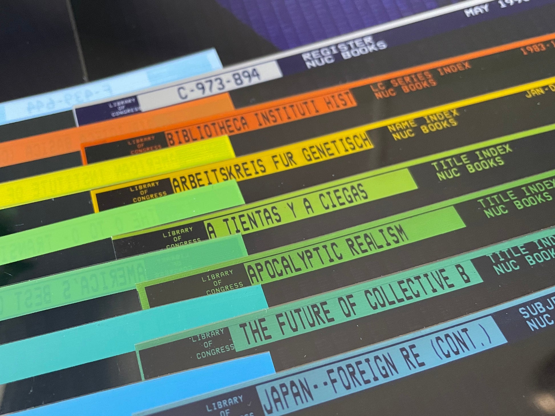 Color-sorted vintage microfiche film sheets photographed in natural light.