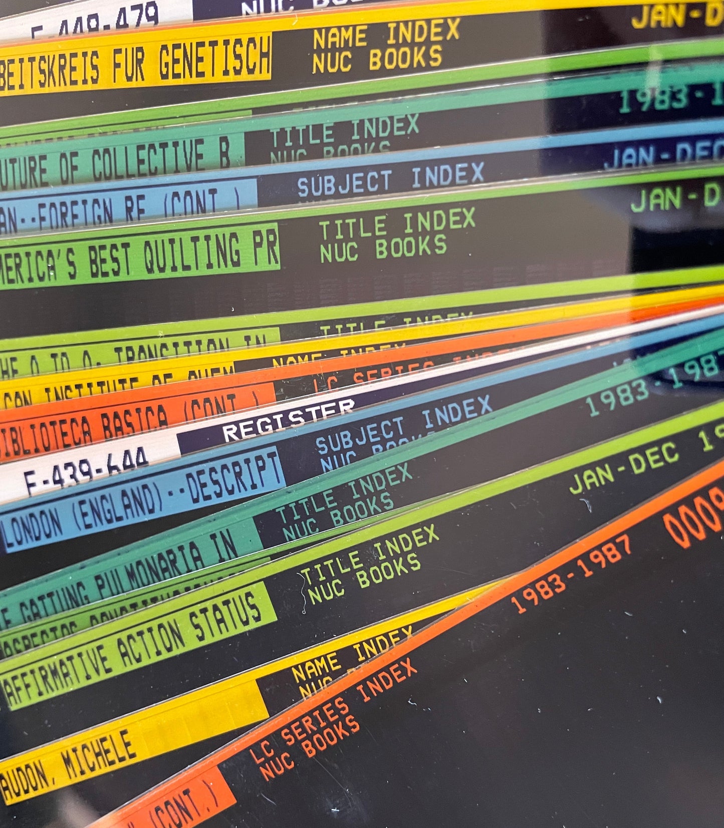 Vintage colored microfiche archive sheets with visible library index text.