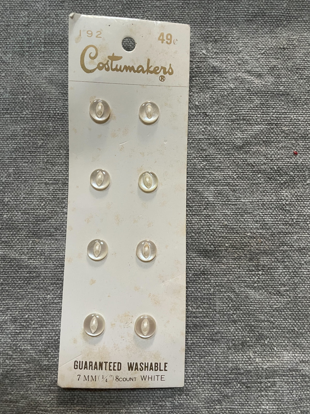 Product view of 8 white costumakers sewing buttons, 7 mm, nos on original card