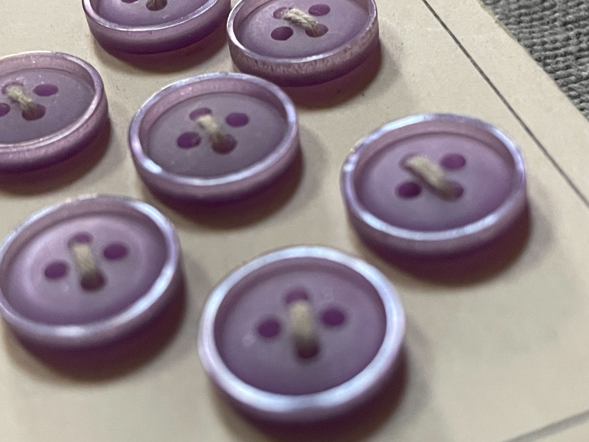 Close-up detail of 7 purple scovill dritz four-hole sewing buttons, 11.5 mm, nos