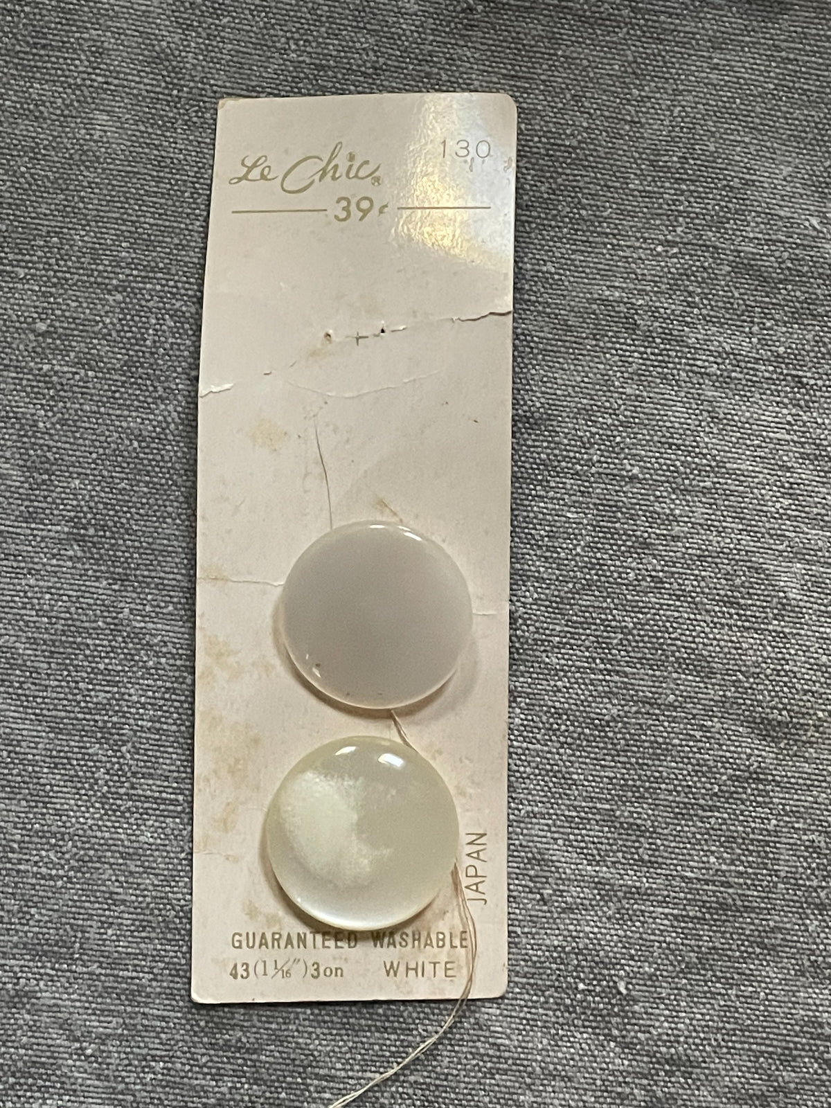 Product view of 2 white le chic sewing buttons, 1 1/16 inch, original card