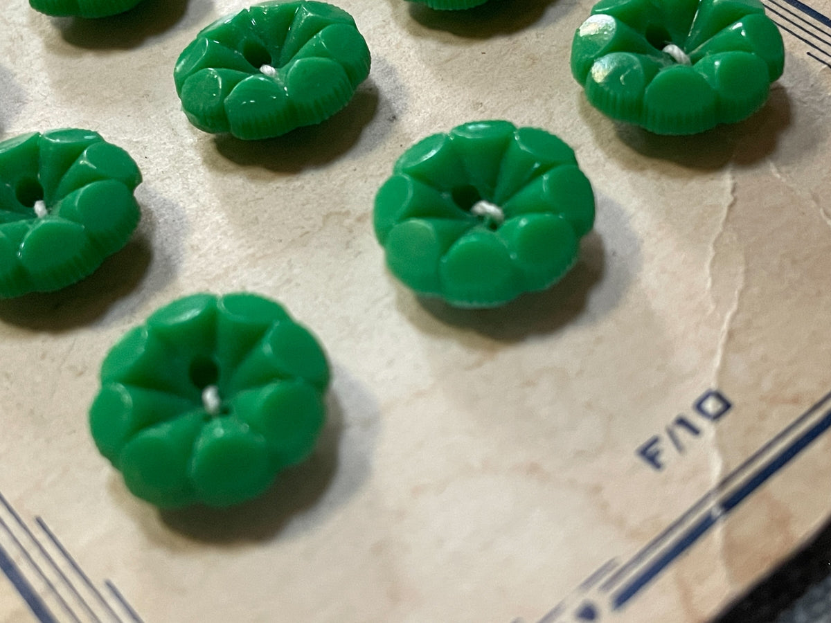 Close-up detail of 9 green flower sewing buttons, 14.84 mm, nos on original card