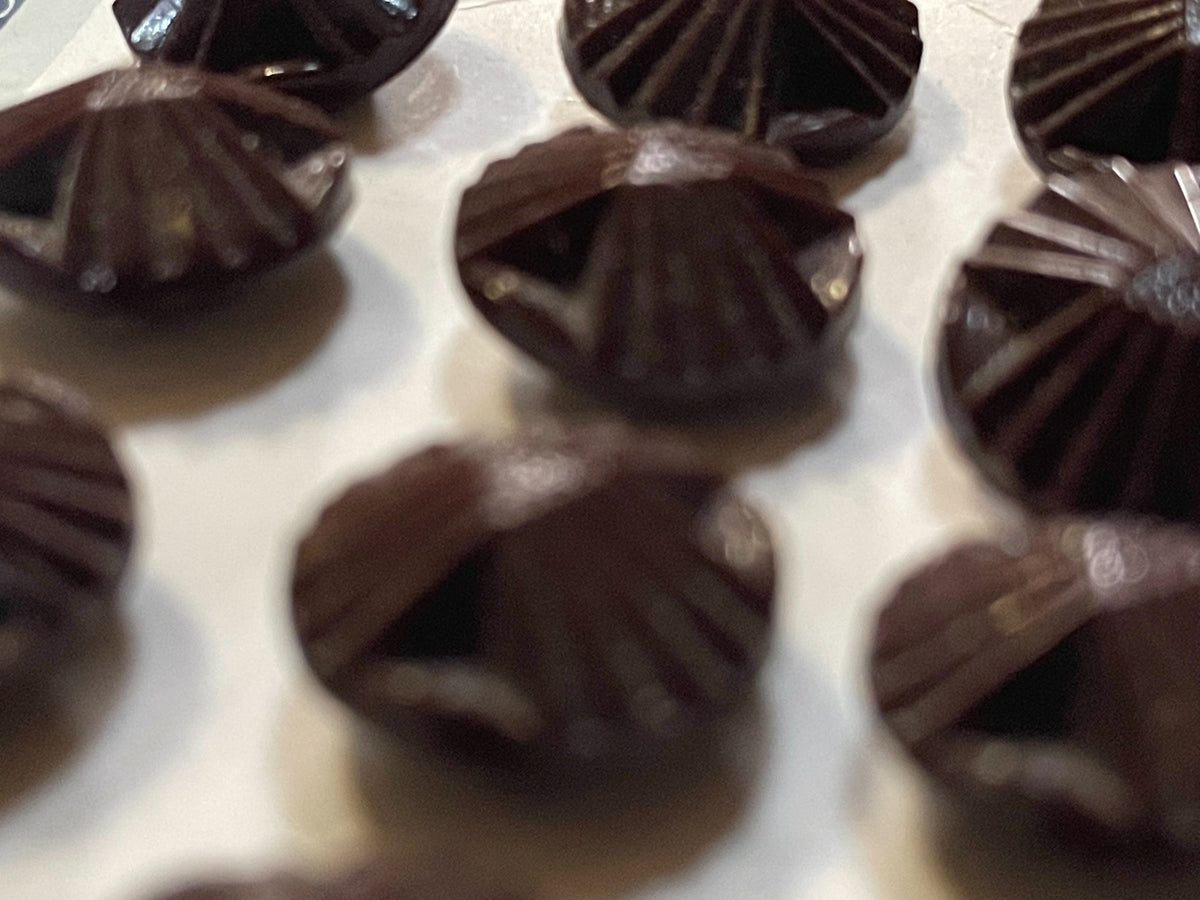 Close-up detail of 12 brown czech glass sewing buttons, 13.18 mm, nos on original card