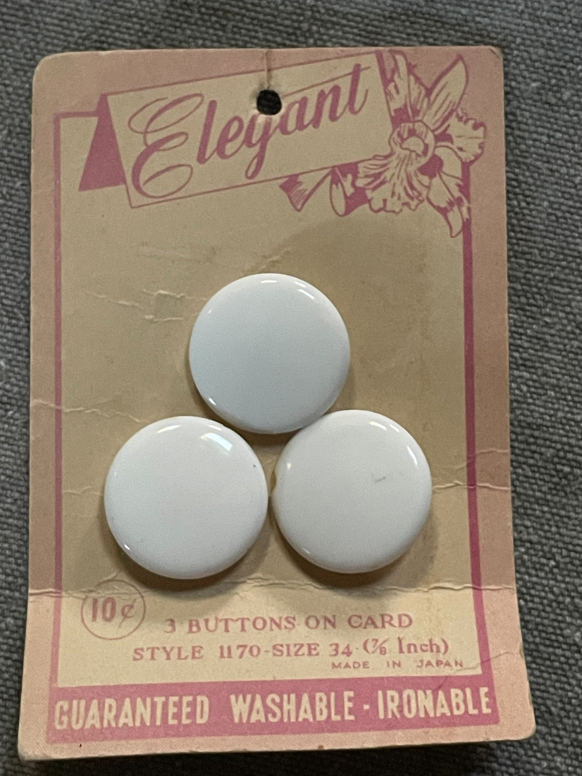 Product view of 3 white elegant sewing buttons, 7/8 inch, nos on original card