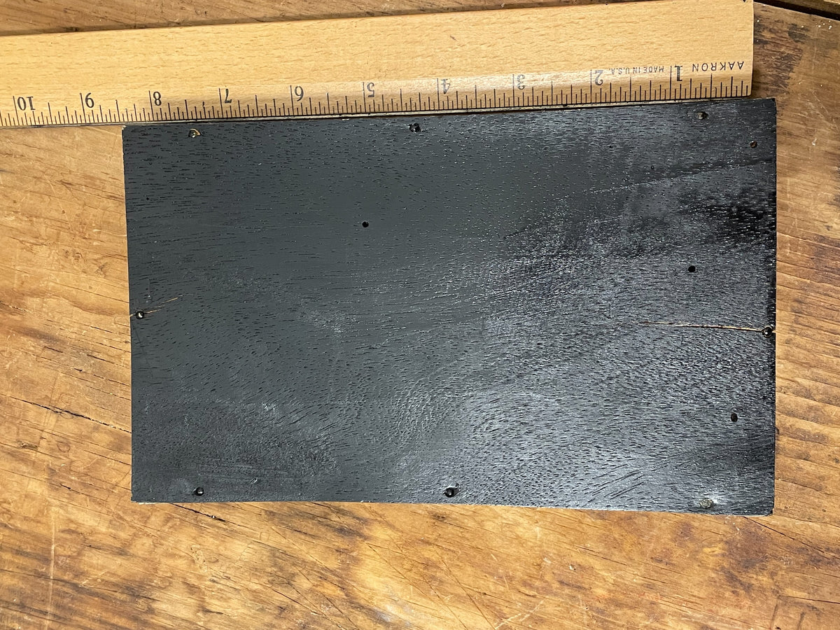 Back of vintage soroban abacus showing plain black panel