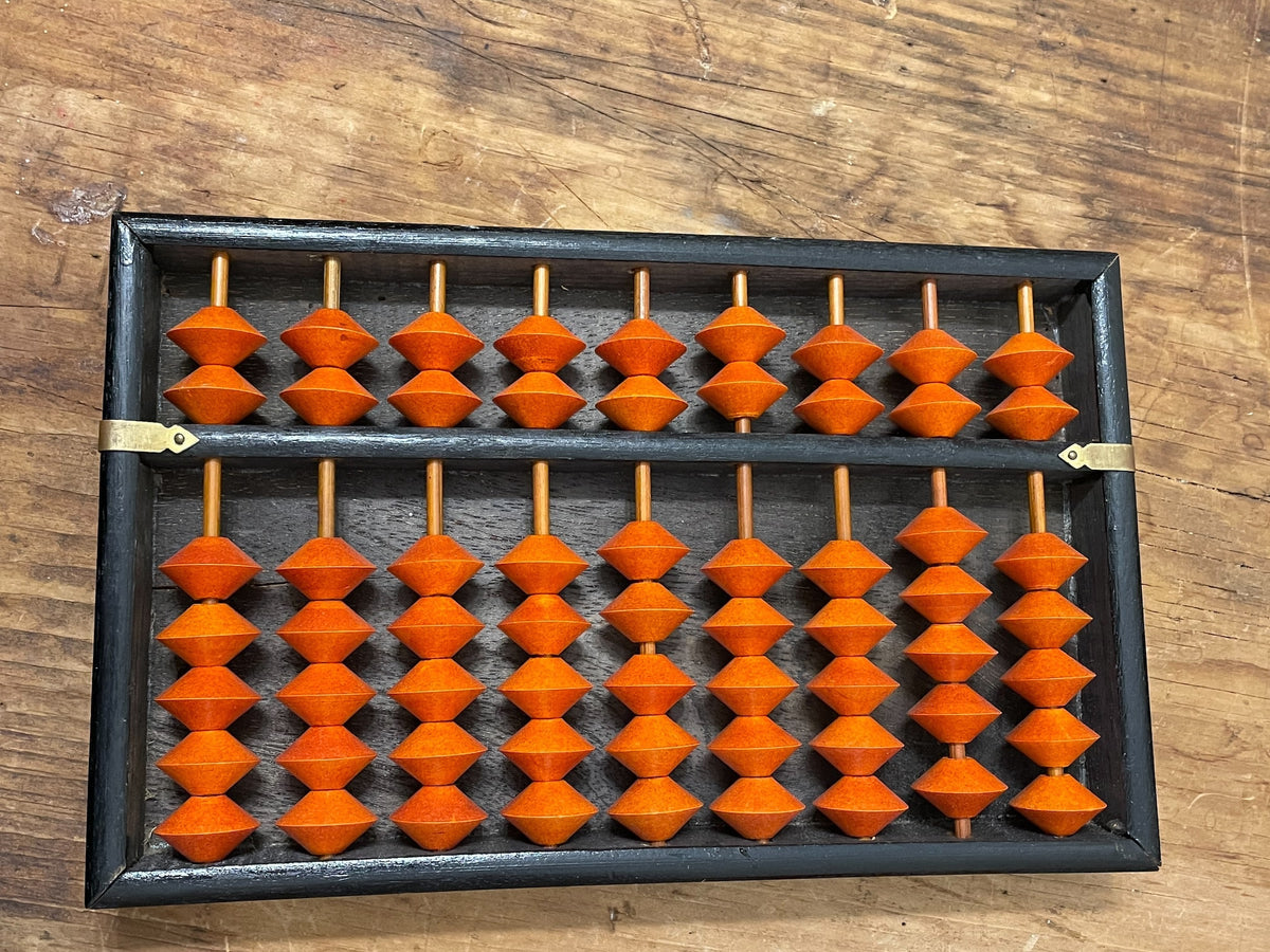 Overhead view of vintage soroban abacus with orange beads