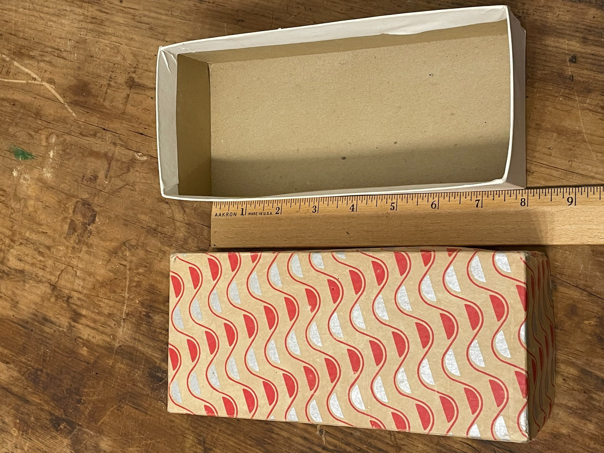 Open vintage paper-covered box showing cream interior and lift-off lid