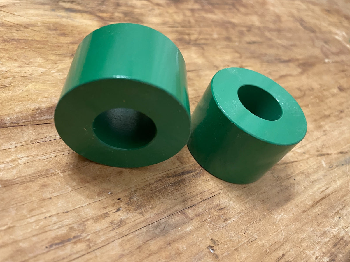 Pair of heavy green cylinder taper candle holders viewed from above