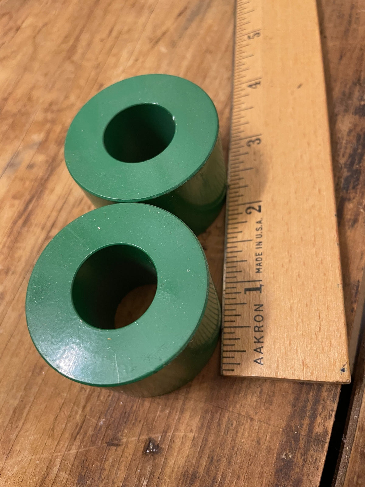 Pair of green candle holders beside ruler showing diameter and scale
