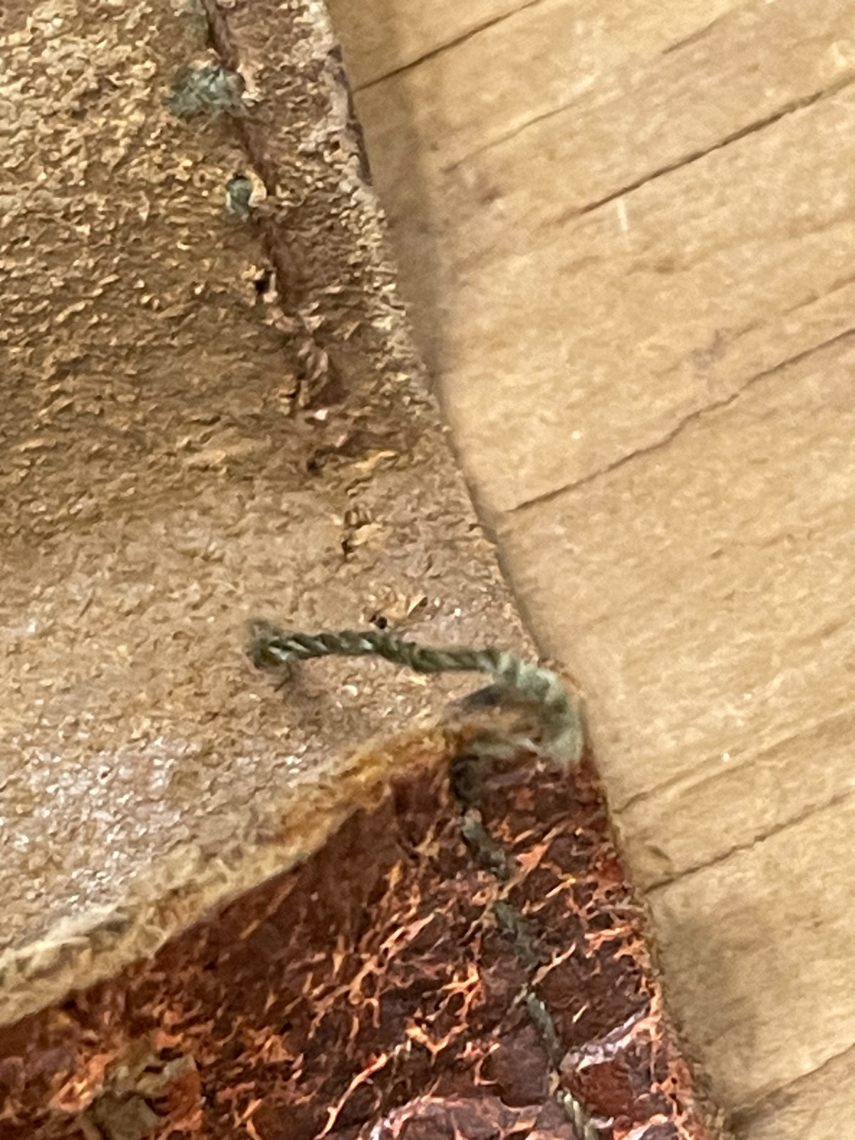 Close-up of worn stitching and edge condition on vintage leather wallet