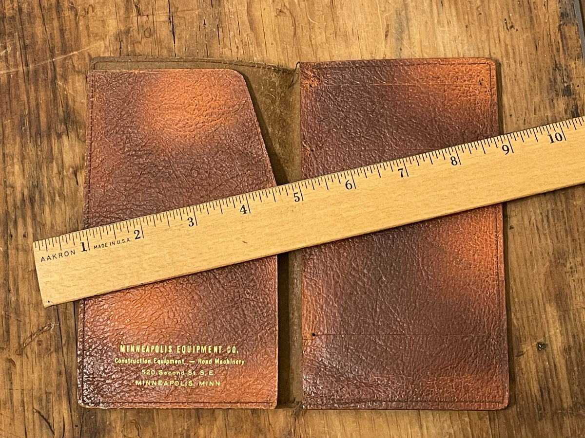 Vintage Minneapolis Equipment Co. leather wallet opened beside ruler for scale