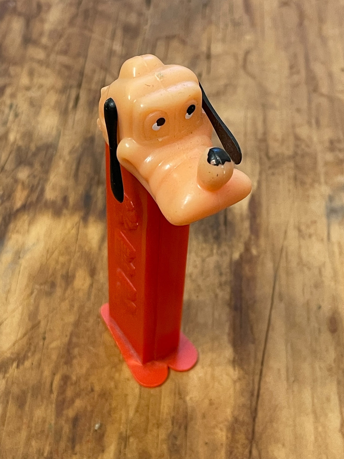 Angled full view of vintage Goofy PEZ dispenser with red no-feet stem