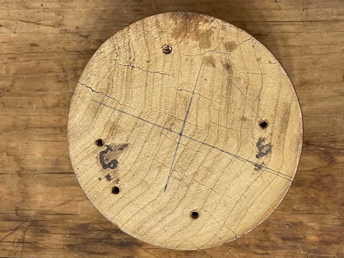 Bottom of rustic turned wood bowl showing old holes and layout marks