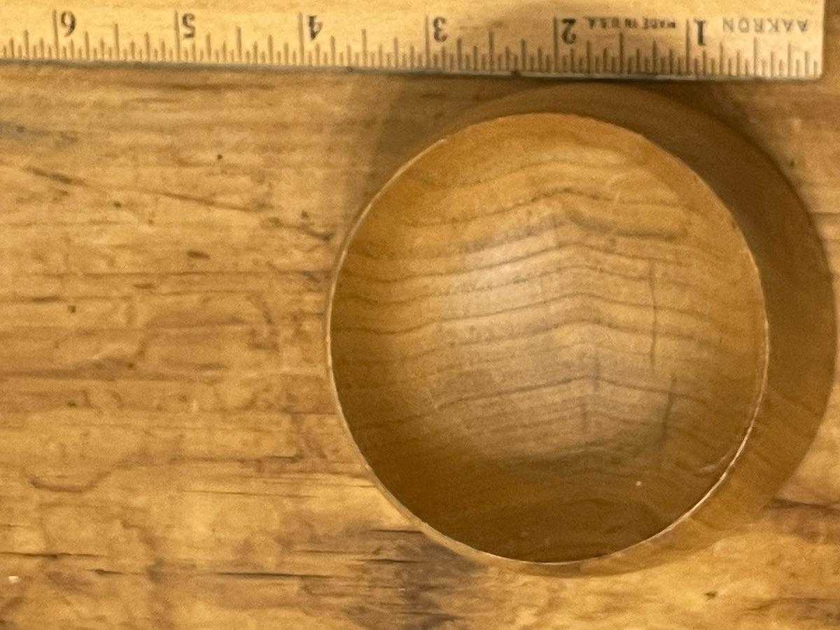 Top view of turned wood bowl beside ruler showing diameter and interior