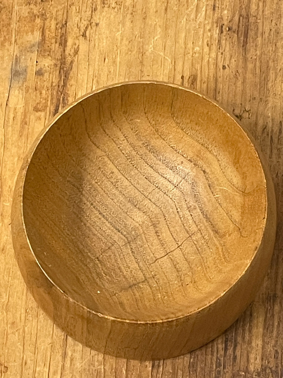 Close-up of wood bowl interior showing grain, checking and cracks