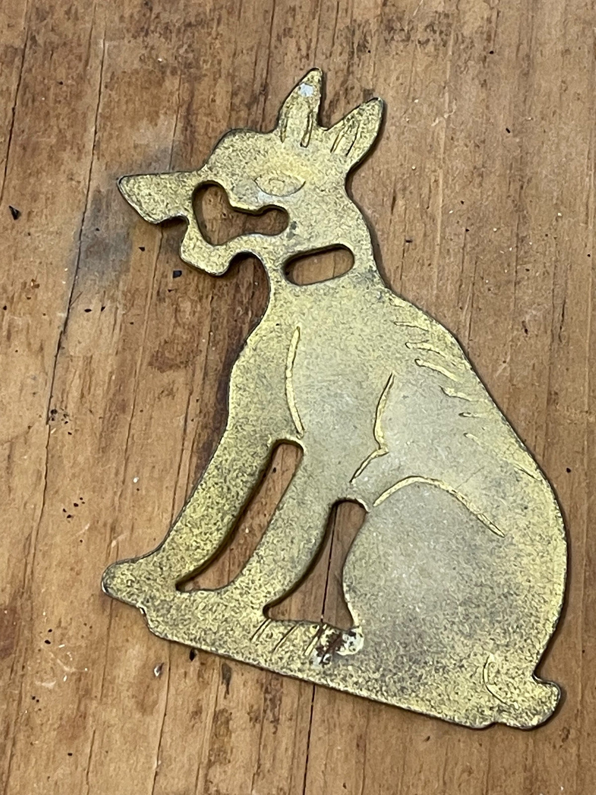 Reverse view of unidentified brass-tone dog figural game piece