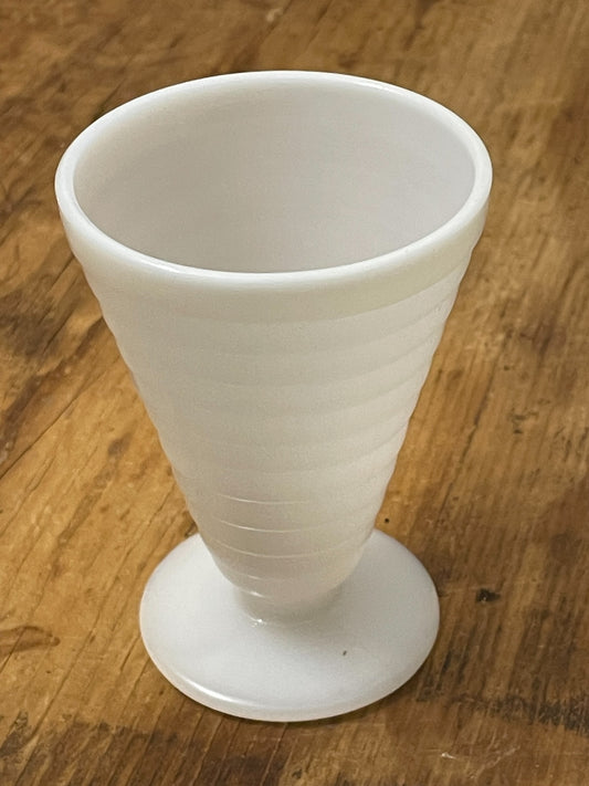 Angled view of vintage white ribbed pedestal sundae or sherbet cup