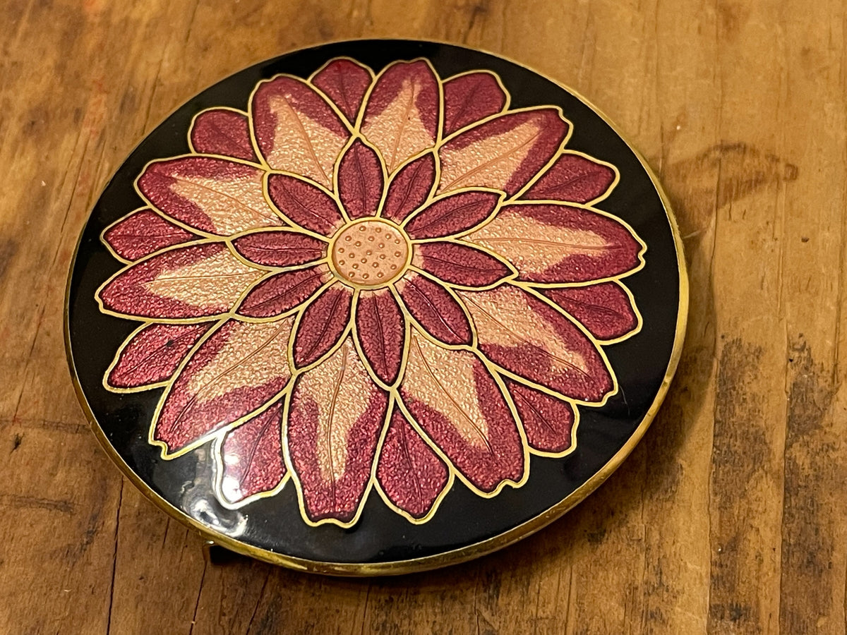 Front of round black belt buckle with pink and cream floral rosette