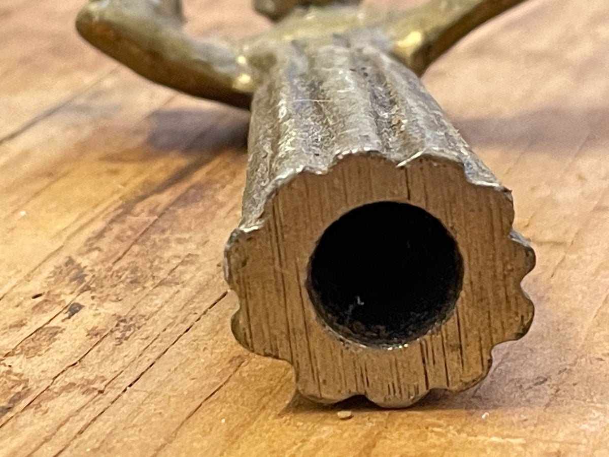 Bottom of cast metal figure showing hollow base