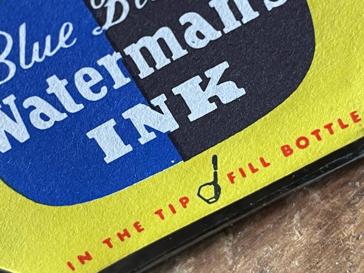 Close-up of a Waterman's Ink packaging with blue, yellow, and black colors.