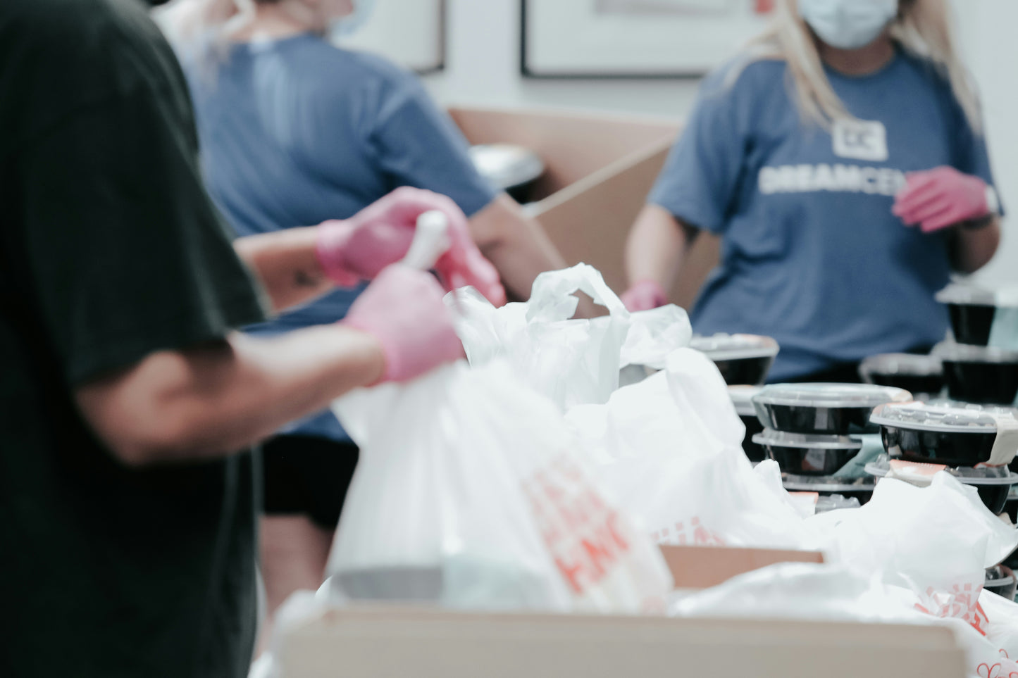 Picture of volunteers packing up food - Photo by Joel Muniz on Unsplash