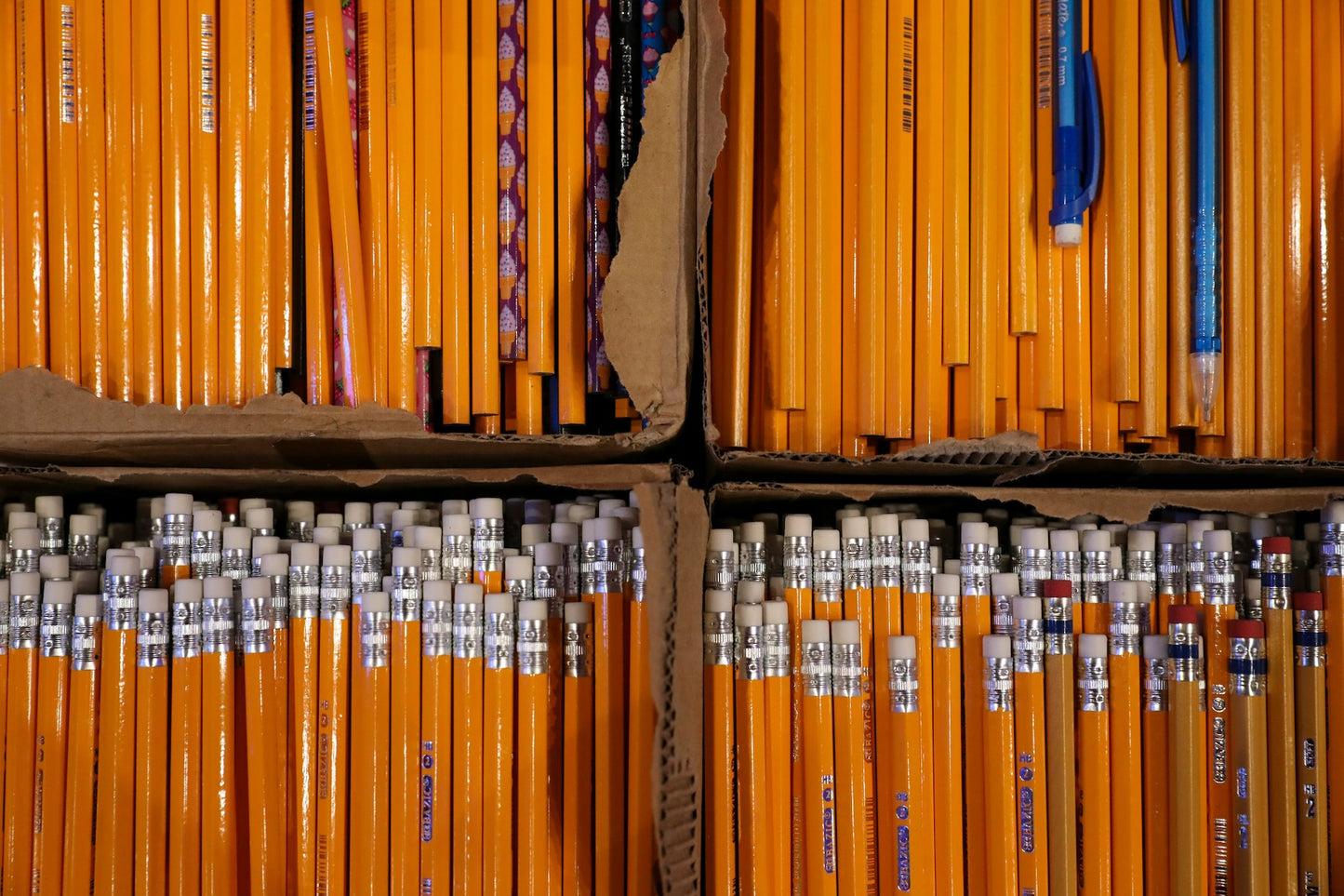 Photo of several hundred unused #2 pencils in torn-open cardboard boxes. Photo by Mick Haupt on Unsplash