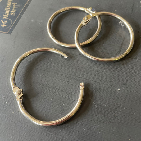 Trio of loose leaf binder rings